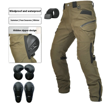 Motorcycle rider wearing green waterproof trousers with removable protective armour on knees and hips.