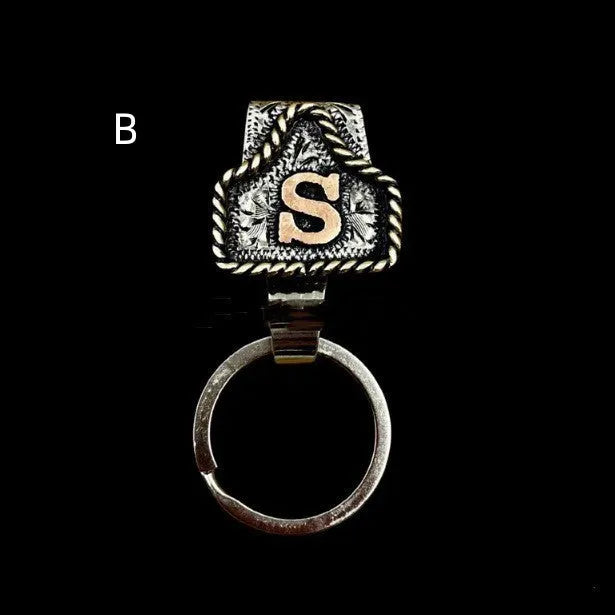 Handmade cow tag design metal keychain on a keyring, shown in one of many available colours.