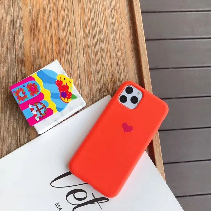 Silicone phone case in solid colours including dark green, flour, light green, light pink, purple and red for iPhone models from 6/6s to 13 Pro Max, offering simple protection with flexible material and precise port cutouts for easy access.