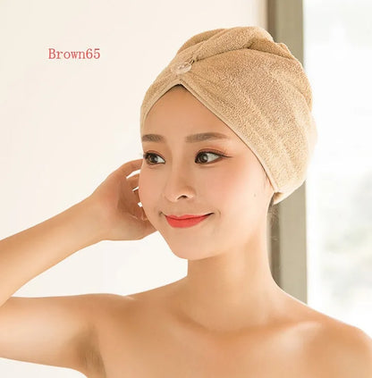 A woman wearing a sky blue microfiber hair dryer cap, with wet hair tucked inside, showing the towel's wrap-around design.