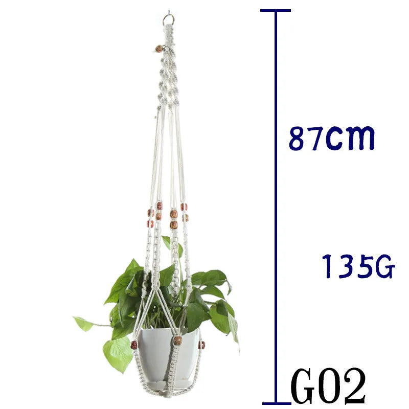 Handmade beige cotton rope net bag holding a plant pot, showing its textured sling design.