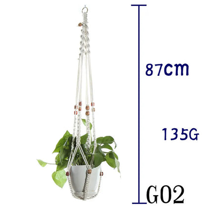 Handmade beige cotton rope net bag holding a plant pot, showing its textured sling design.