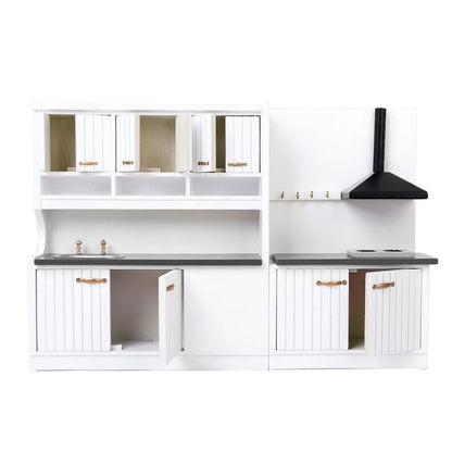 White dollhouse kitchen sink and stove cabinets with working doors and metal handles.