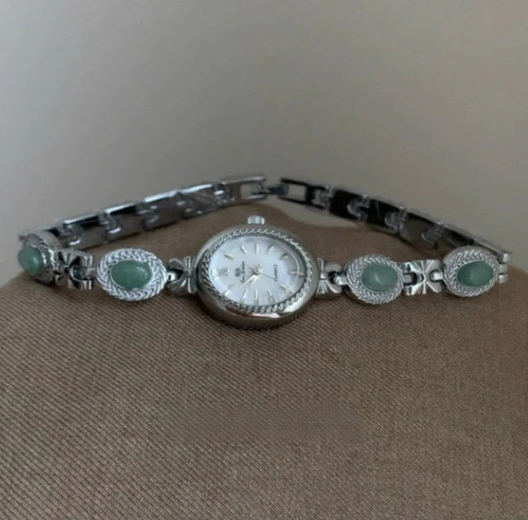 Green jade and silver ladies watch with white dial showing modern Chinese design