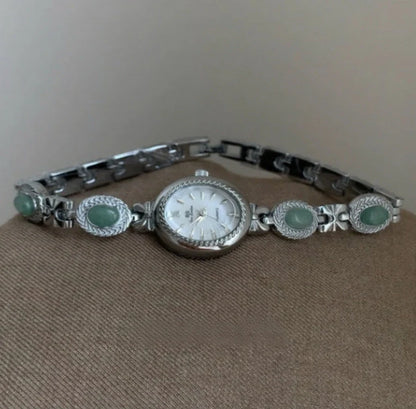 Green jade and silver ladies watch with white dial showing modern Chinese design