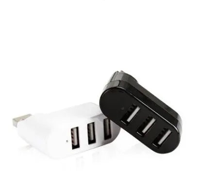 Black and white USB 2.0 hub splitter with spin colour casing on a desk next to a laptop.