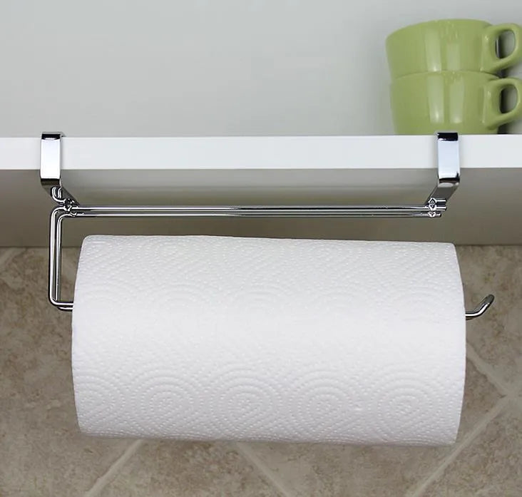 Silver stainless steel paper towel rack hanging on a cabinet door