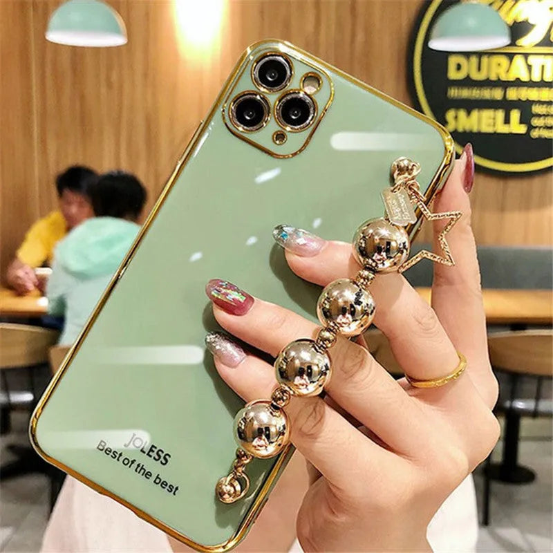 Electroplated bead wrist strap bracelet case for iPhone in light green, pink, and dark green, TPU back cover.