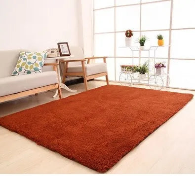 Solid colour plush rectangle area rug with soft texture on a wooden floor.