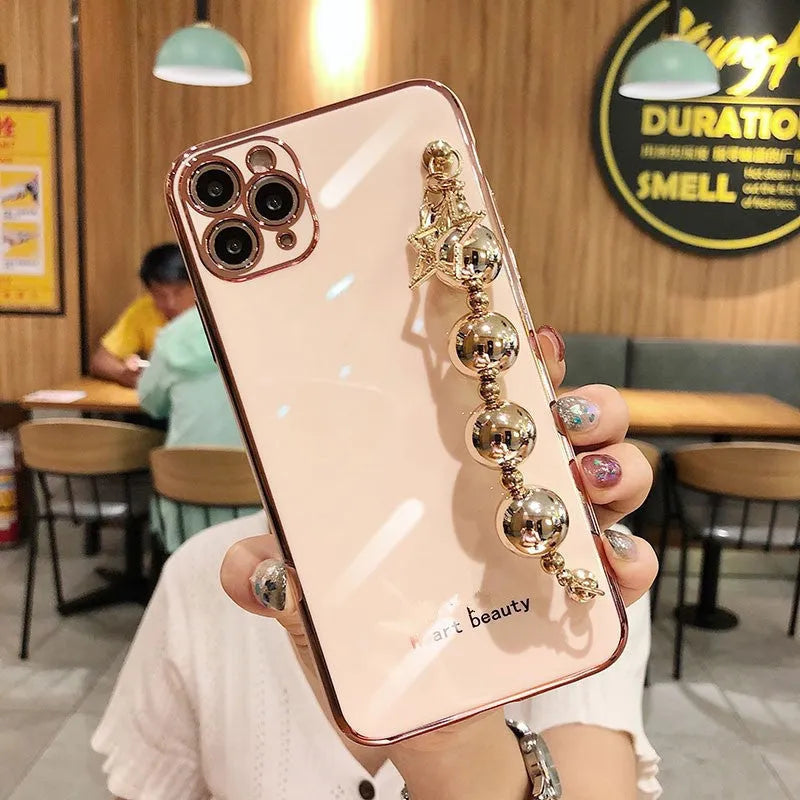 Electroplated bead wrist strap bracelet case for iPhone in light green, pink, and dark green, TPU back cover.