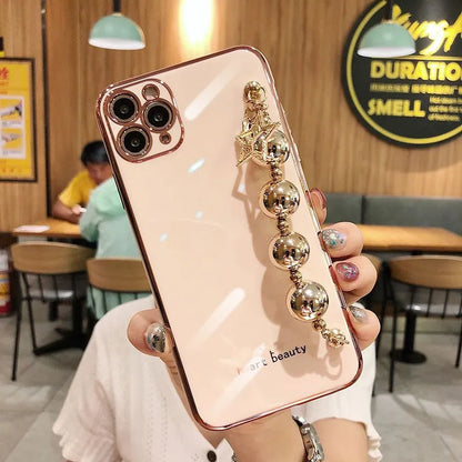Electroplated bead wrist strap bracelet case for iPhone in light green, pink, and dark green, TPU back cover.