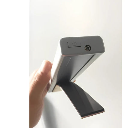 Wireless LED wardrobe light in 300mm size with motion sensor and charging pad, warm white glow, mounted on shelf