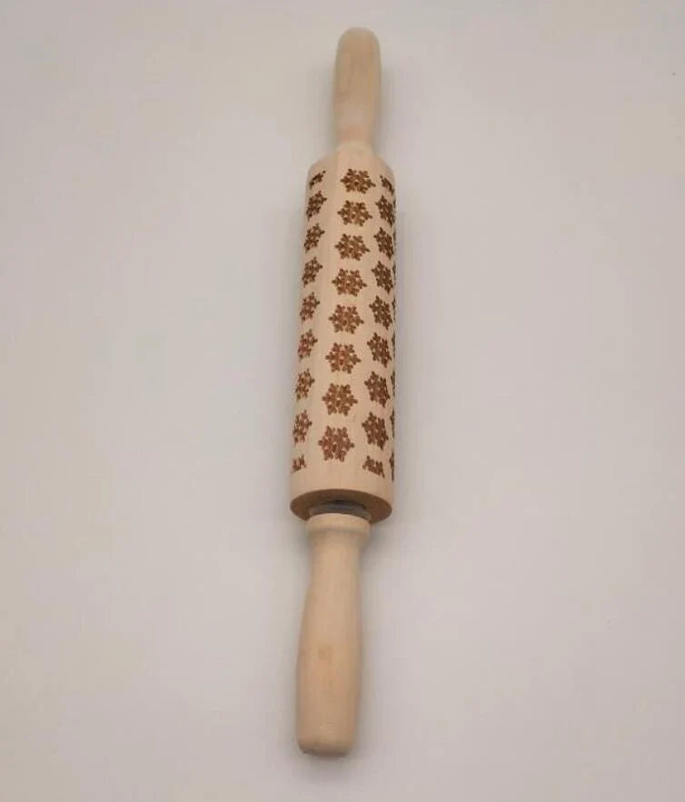 Festive rolling pin with embossed Christmas designs for easy imprinting on dough