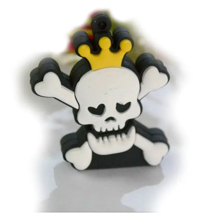 Skull-shaped black USB flash drive on a small metal keychain against a dark background.