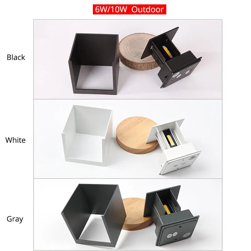 Compact square aluminium wall lamp with 360-degree light output, shown in grey finish mounted on a wall.