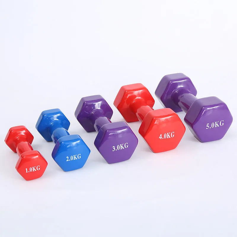 Set of bright coloured plastic-coated fitness dumbbells in 0.5kg, 1kg, and 1.5kg weights on a floor.