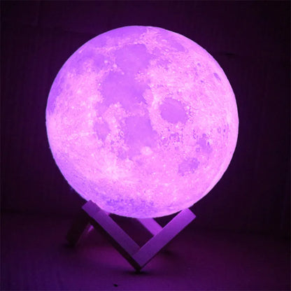 3D printed white moon lamp on a wooden holder, showing detailed crater texture and soft LED glow.