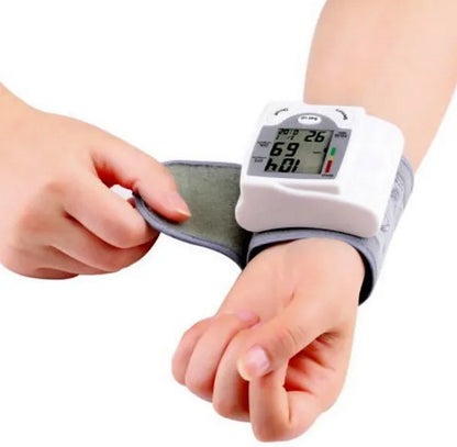 Grey portable wrist blood pressure monitor with digital display and ABS plastic casing