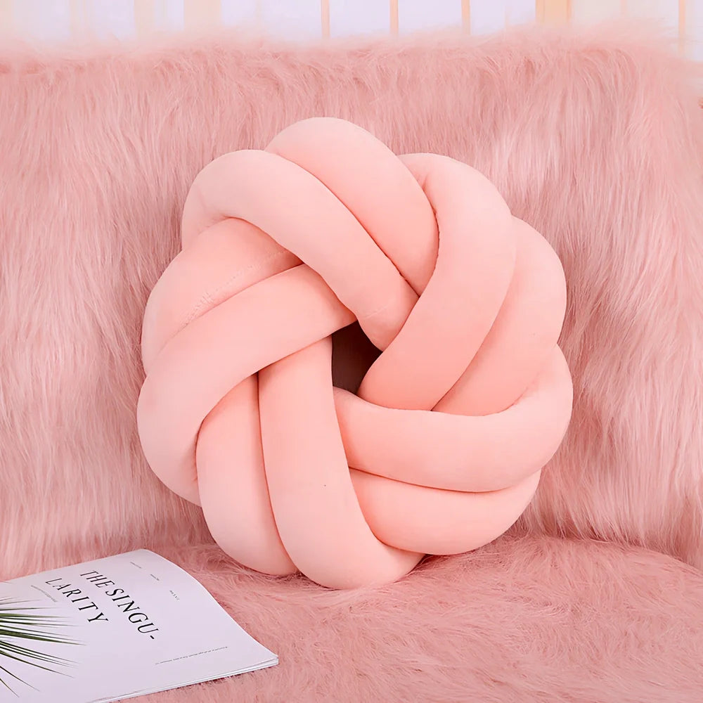 Knotted lumbar pillow with memory foam fill showing adjustable height feature and polyester cover