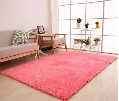 Solid colour plush rectangle area rug with soft texture on a wooden floor.