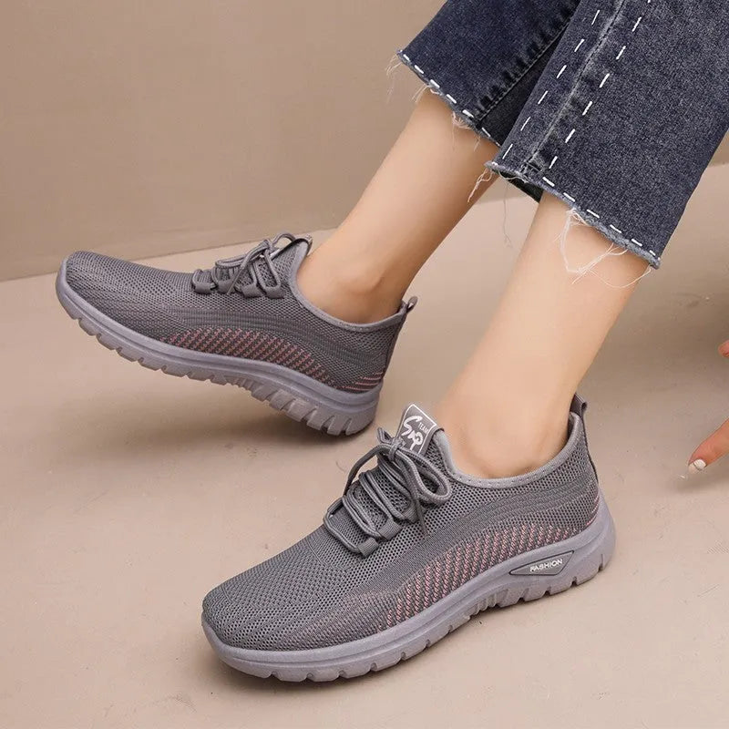 Women's black breathable mesh sneakers with round toe and cross strap lace-up detail
