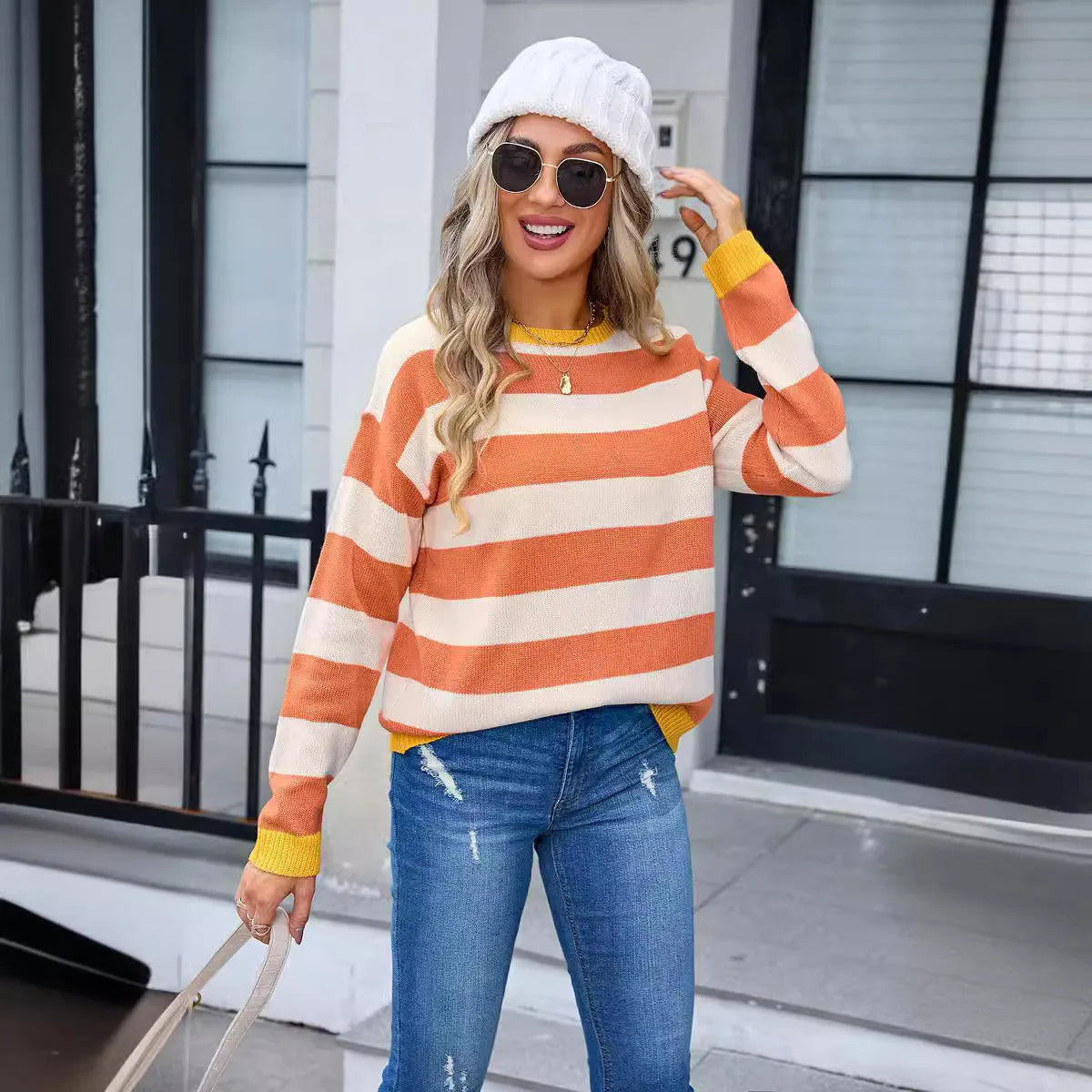 Women's loose blue striped acrylic sweater with long sleeves and round neck.