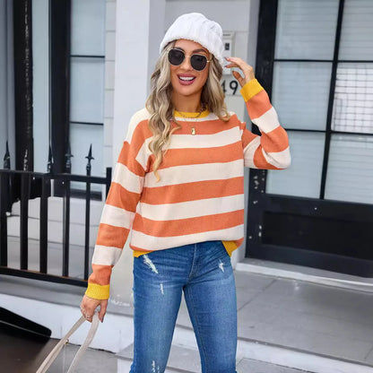 Women's loose blue striped acrylic sweater with long sleeves and round neck.