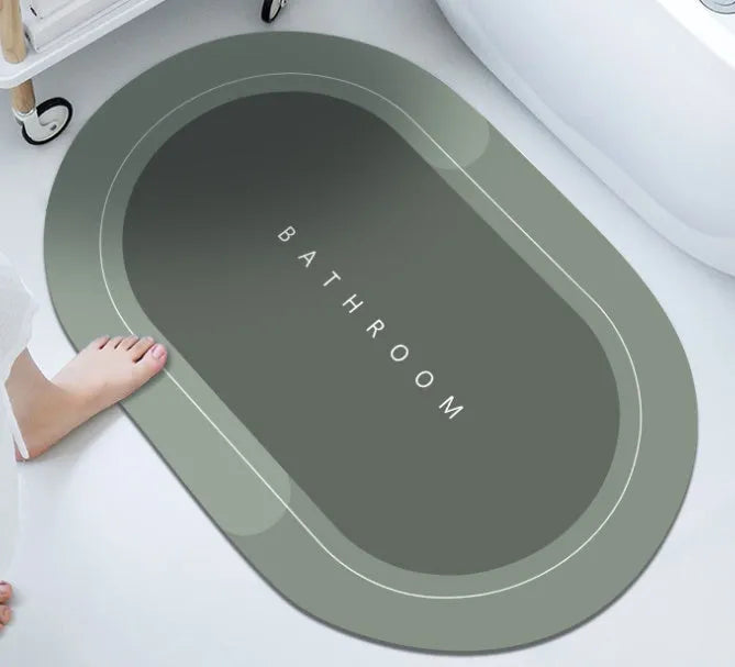 Oval diatomite bathroom floor mat in blue with natural rubber non-slip backing on tiled floor.