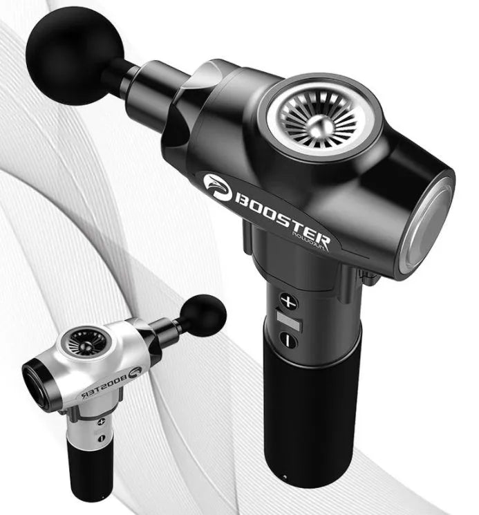 Black and white handheld percussion muscle massage gun with four interchangeable foam heads on a grey background.