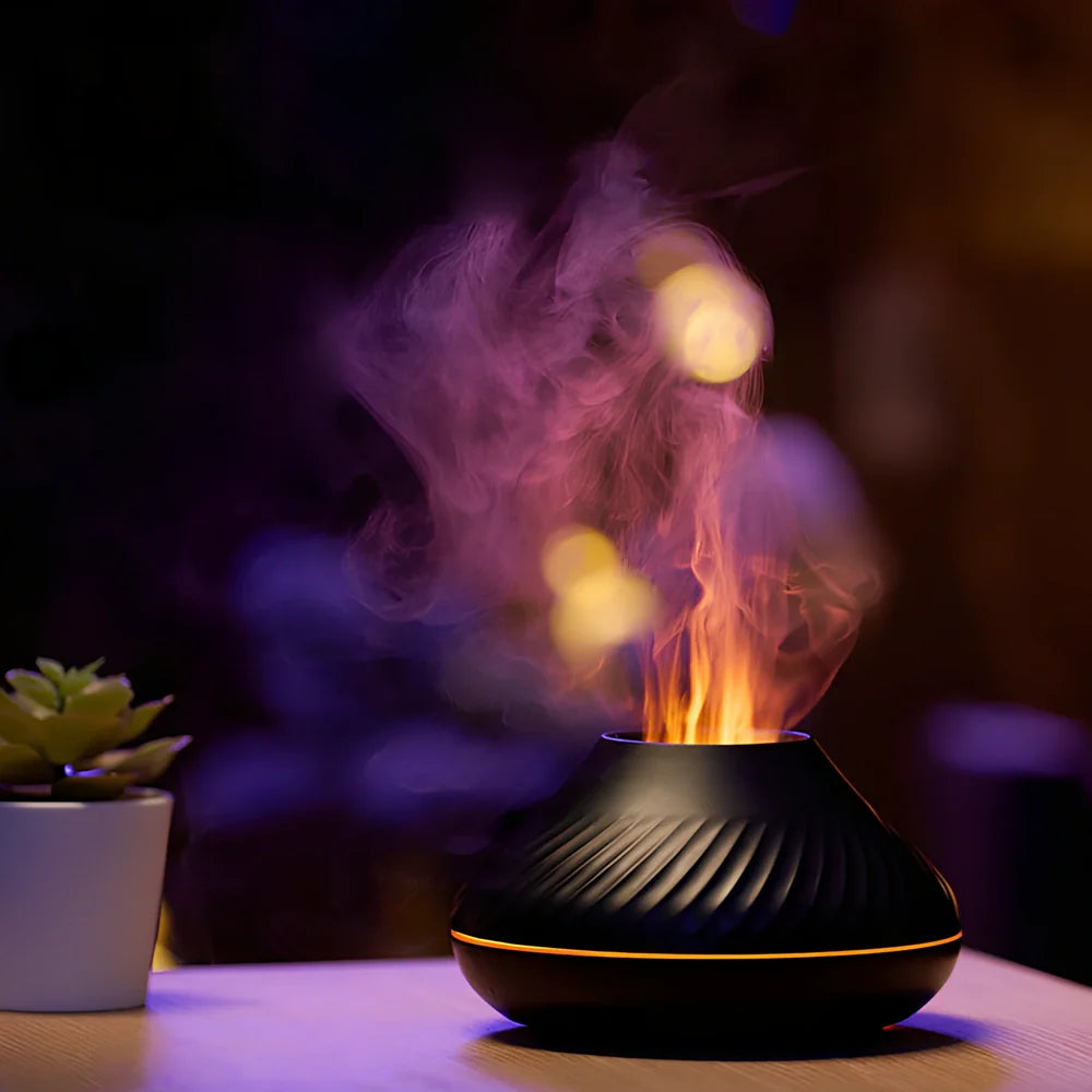 Black RGB flame aroma diffuser 130ml showing 3D colourful volcano mist effect on table