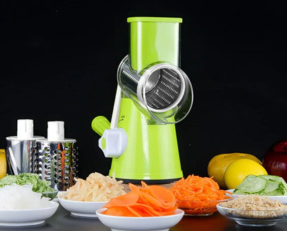 Blue multifunctional round mandoline vegetable slicer and cheese grater with stainless steel blades on a kitchen counter.
