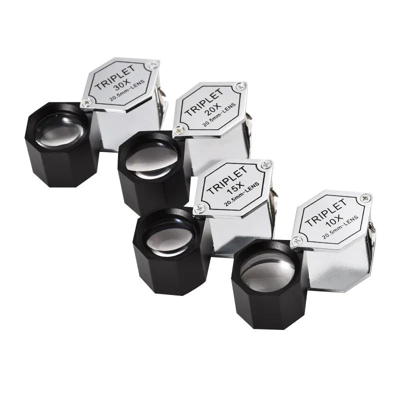 Handheld metal magnifying glass with optical glass lens for jewellery and coin inspection.