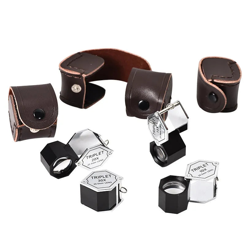 Handheld metal magnifying glass with optical glass lens for jewellery and coin inspection.