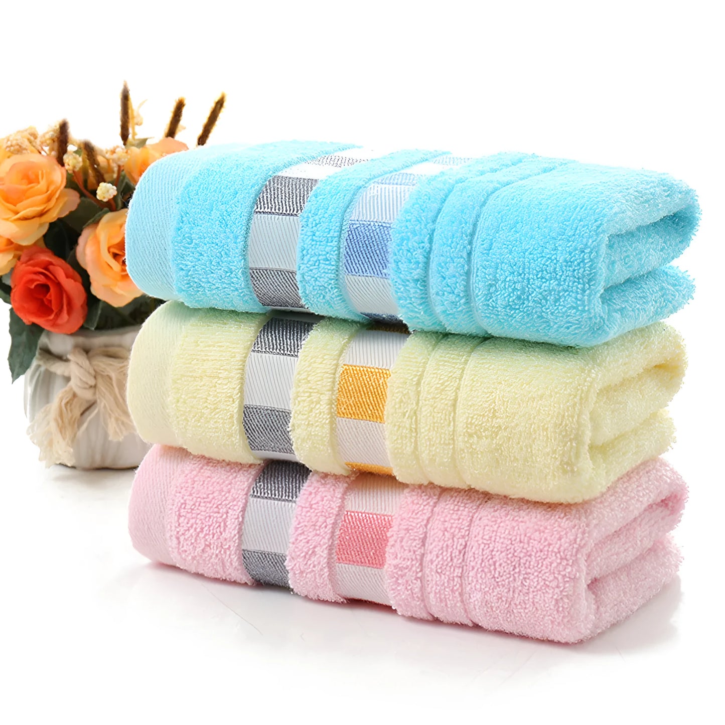 Cotton face towel in blue, pink and yellow colours with heart patterns, dimensions 73x33cm