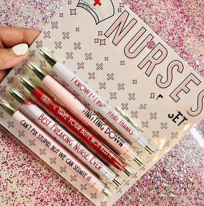 Set of five white plastic retractable ballpoint pens with blue and red nurse-themed text and graphics.