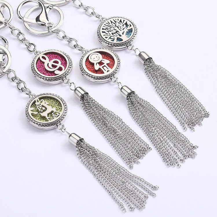 Alloy car aromatherapy pendant with tassel on 50cm chain beside coloured cotton pads for fragrance diffusion