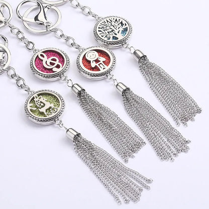 Alloy car aromatherapy pendant with tassel on 50cm chain beside coloured cotton pads for fragrance diffusion