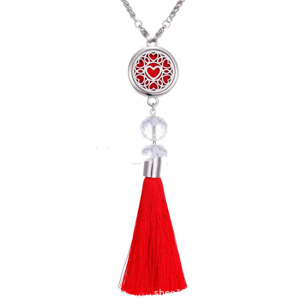 Alloy car aromatherapy pendant with tassel on 50cm chain beside coloured cotton pads for fragrance diffusion