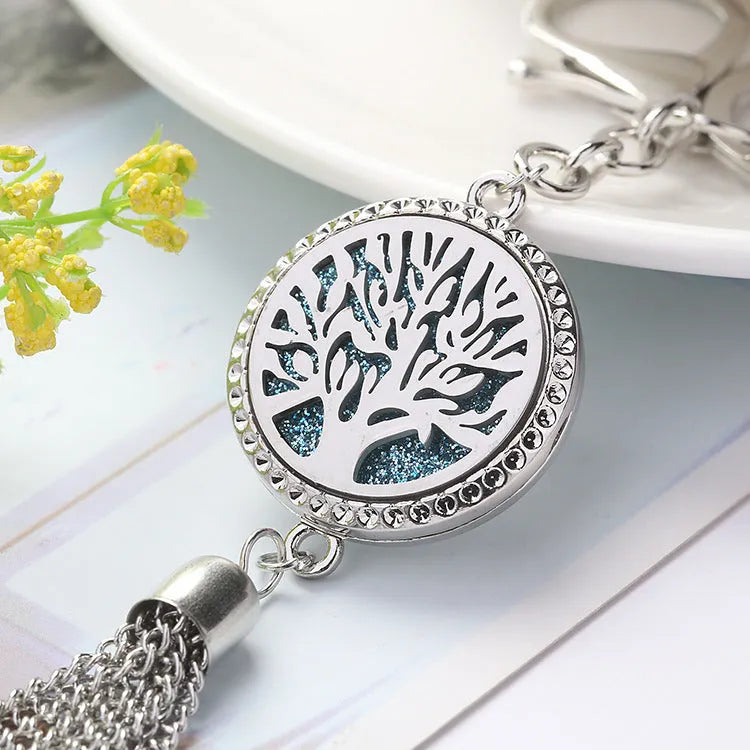 Alloy car aromatherapy pendant with tassel on 50cm chain beside coloured cotton pads for fragrance diffusion