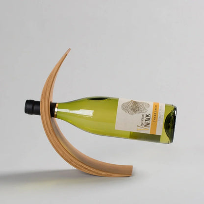 Natural bamboo wine bottle rack holding six bottles with wood grain visible
