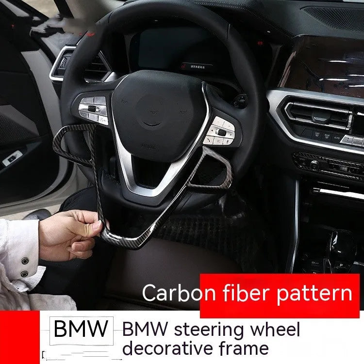 Carbon fibre pattern decorative button frame for BMW steering wheel.