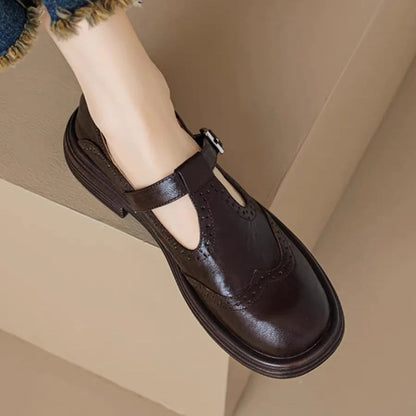 Women's black and brown round-toe flat casual shoes made from sheepskin leather.