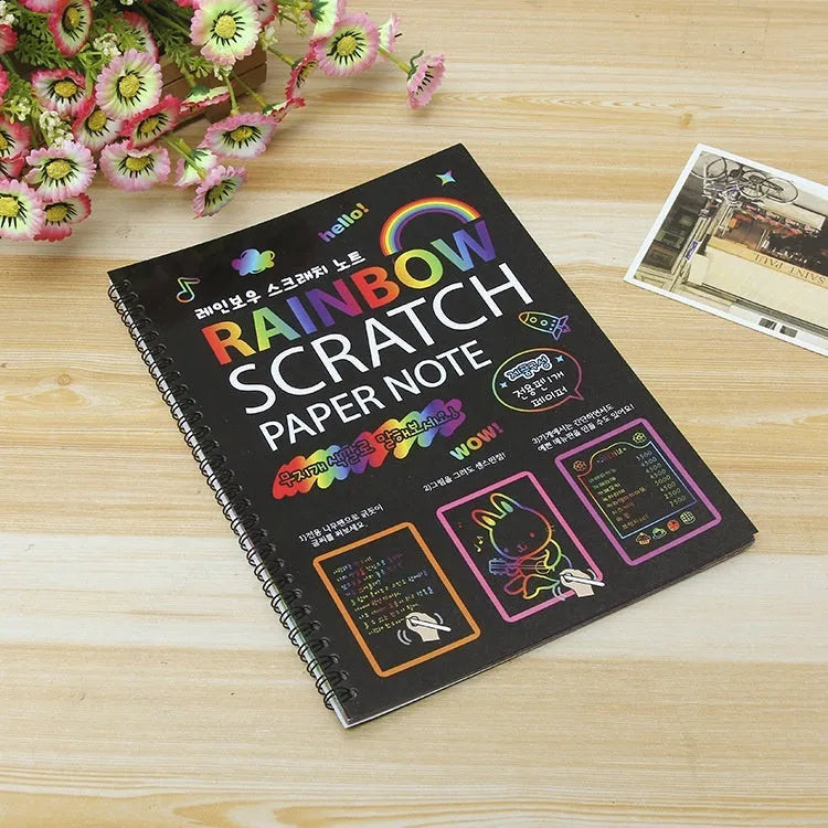 Children's large scratch art paper showing colourful patterns revealed through scraping