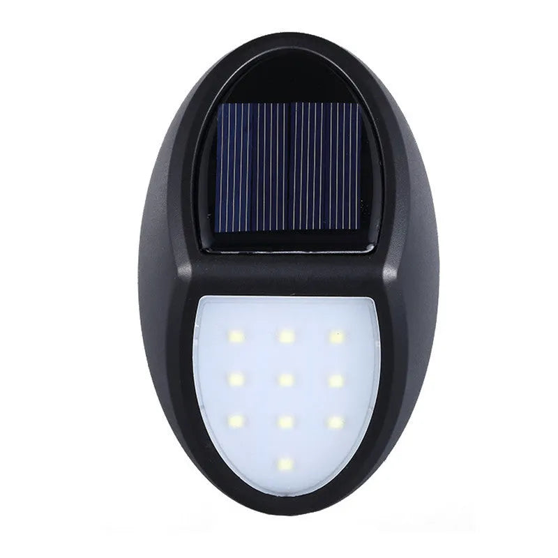 Black rectangular LED solar wall light with solar panel on top for outdoor security.