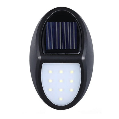 Black rectangular LED solar wall light with solar panel on top for outdoor security.