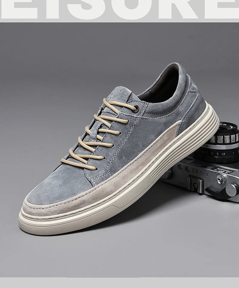 Men's grey low-top casual leather skate shoes with round toe and flat rubber sole on a neutral background.