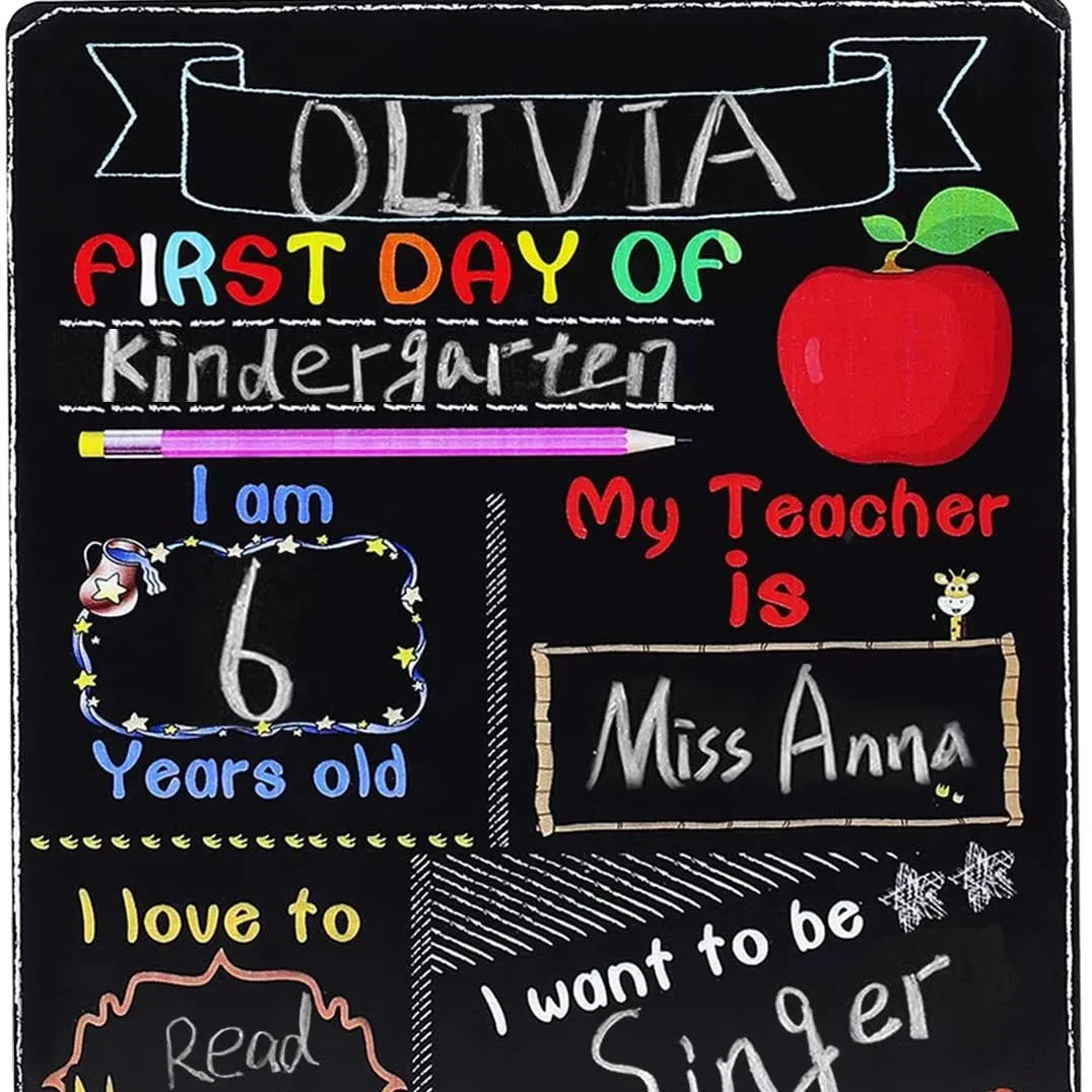 Wooden first day of school blackboard sign on a natural wood background.