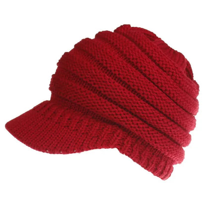 Women's acrylic knitted ponytail beanie in a solid colour, shown on a model with a ponytail.