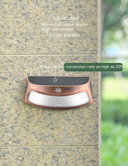 Solar outdoor wall lamp with smiling face design, dimensions 153mm by 76mm by 38mm