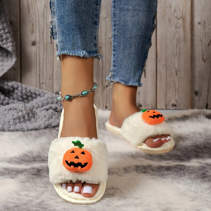 White and yellow plush pumpkin slippers with open toe and textured anti-slip sole on wooden floor.
